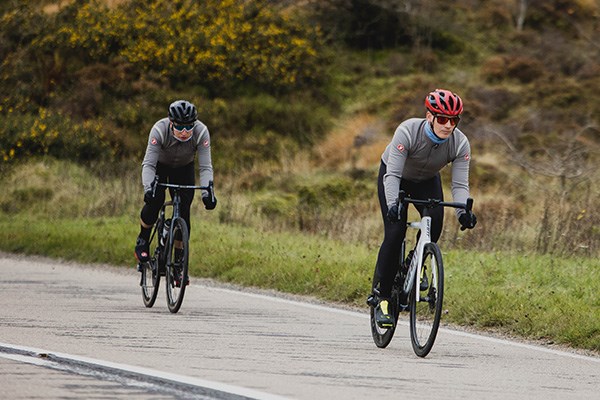 Two road riders riding Giant and Cannondale wearing castelli